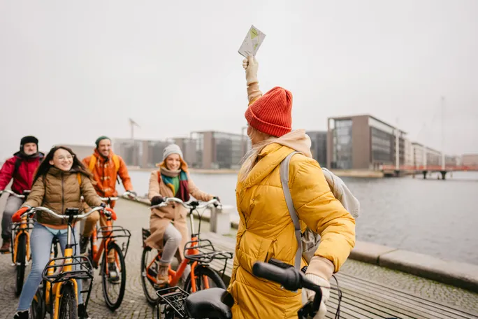 Tour-guide-giving-directions-to-a-small-group-